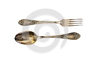 Silver cutlery set with fork, knife and spoon isolated on a white background.