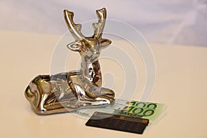 Silver deer symbol of financial success, banknotes and calculator, euro banknotes and calculator, background photo