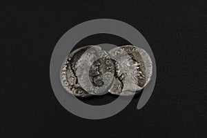 Silver denarius coins of Ancient Rome on a black background