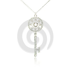 Silver diamond key pendant isolated on white