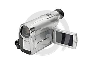 Silver digital camcorder with open lcd screen on a black background
