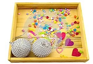 Silver disco ball and heart â€“ shaped paper for Christmas holiday in wooden box isolate on white background