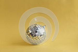 Disco ball with sparkle on golden background