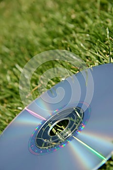 Silver DVD on green grass