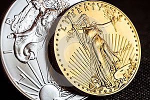 silver eagle and golden american eagle one ounce coins photo