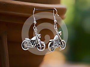 Silver earrings in biker style. Small jewelry and bijouterie