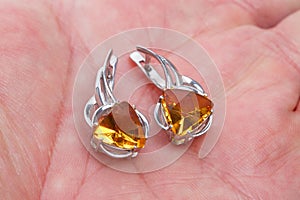 Silver earrings with citrine on the palm
