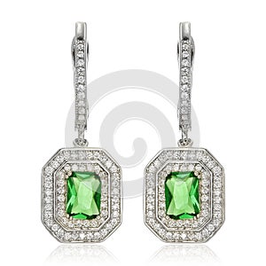 Silver earrings with emeralds on white