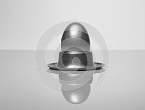 Silver egg in metal eggcup