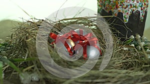 Silver eggs in a red ribbon and Easter cake on a white background, slider shooting