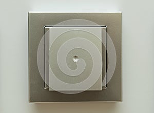 Silver electrical light switch on a wall