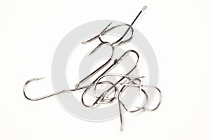 Silver fishing hooks on white