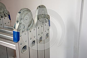 Silver folding ladder close-up, structurally stable