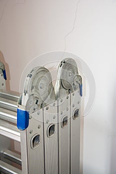 Silver folding ladder close-up, structurally stable