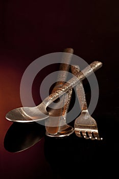 Silver fork, knife and spoon over black background