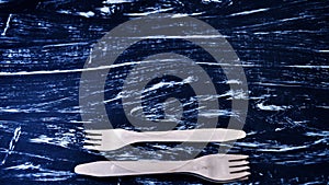 Silver fork lying on a wooden table. Cutlery for eating. Device photo