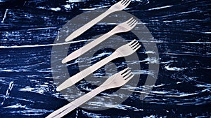 Silver fork lying on a wooden table. Cutlery for eating. Device photo