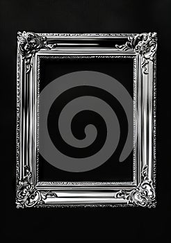 A silver frame with ornate details on a black background