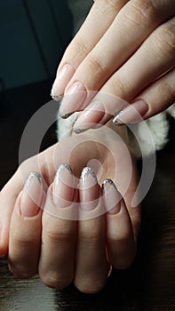 Silver french manicure with glitter, both hands