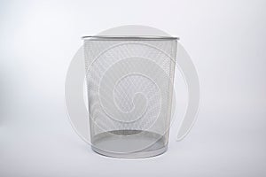 Silver garbage can isolated on a gray background