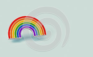 Silver gay pride rainbow pin isolated on pastel green background. Copy space on the right side. LGBTQ and homosexual minority