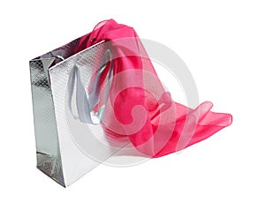 Silver gift bag and pink silk scarf on white