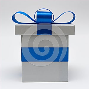 Silver gift box with blue satin bow ribbon on white background