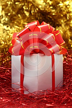 Silver gift wrapped present with red bow