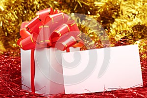 Silver gift wrapped present with red bow