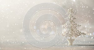 Silver glitter Christmas tree on grey background with lights bokeh, copy space. Greeting card for new year party. Festive holiday photo