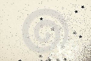 Silver glitter and glittering stars sparkle on white background in vintage nostalgic colors