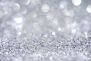 Silver glittering Christmas lights. Blurred abstract background