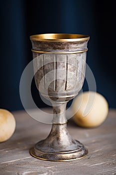 a silver goblet with gold rim