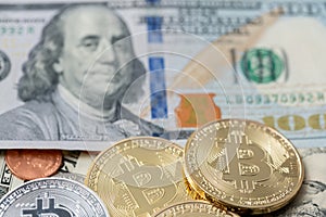 Silver and Gold Bitcoin on one hundred Dollar Banknotes and Coins. Digital Crypto currency with US Dollar Bills and pennies.