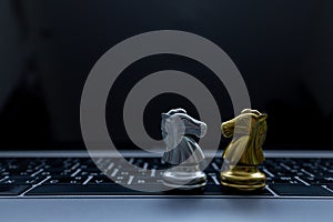 Silver and Gold chess on laptop, Marketing or business strategy, Chess battle victory success, Team leader teamwork business