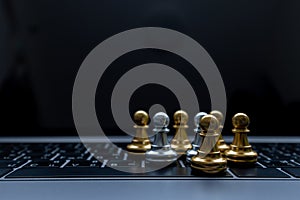 Silver and Gold chess on laptop, Marketing or business strategy, Chess battle victory success, Team leader teamwork business