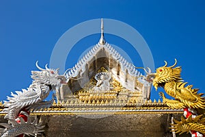 Silver and Gold Dragon entwine temple pole at Wat Muang - Ang Thong, Thailand