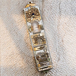 Silver and gold mezuzah with image of Jerusalem photo
