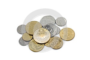 A silver and gold pile of coins from Ukraine on a white background