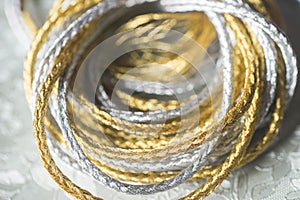 Silver and gold twine on silverbackground