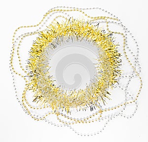 Silver and golden beads, chain with balls, round empty blank circle of yellow tinsel. New year decorations of on white background
