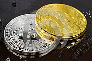 Silver and golden bitcoins on the black background closeup. Cryptocurrency virtual money