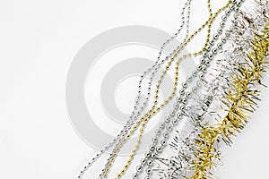 Silver and golden chain with balls, beads, yellow tinsel. New year decorations on a white background. Christmas concept. Template