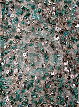 Silver and green blue glass seed beads and sequined mesh fabric texture