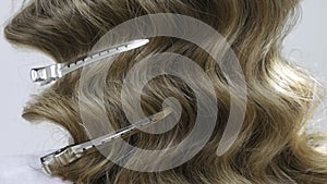 Silver hairdressers clips in wavy hair