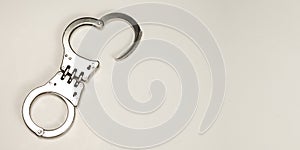 Silver handcuff isolated on gray banner with copy space