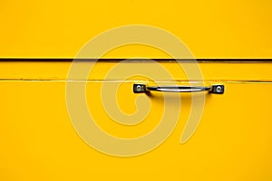 Silver handle at yellow metal box