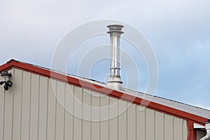 silver iron chimney pipe of the stove in the house