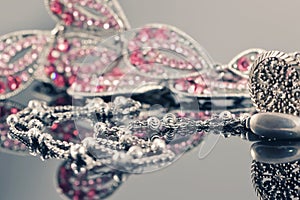 Silver jewelry on the background of a jewellery with pink stones