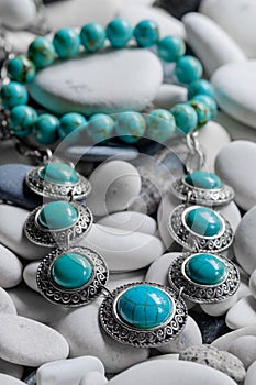 Silver jewelry on pebbles